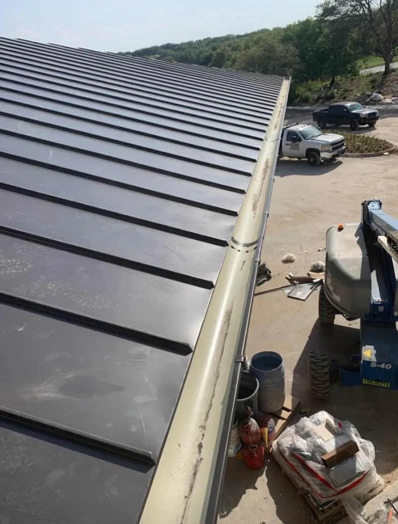Standing seam panel and gutter detail on a metal roofing jobsite in Riverside
